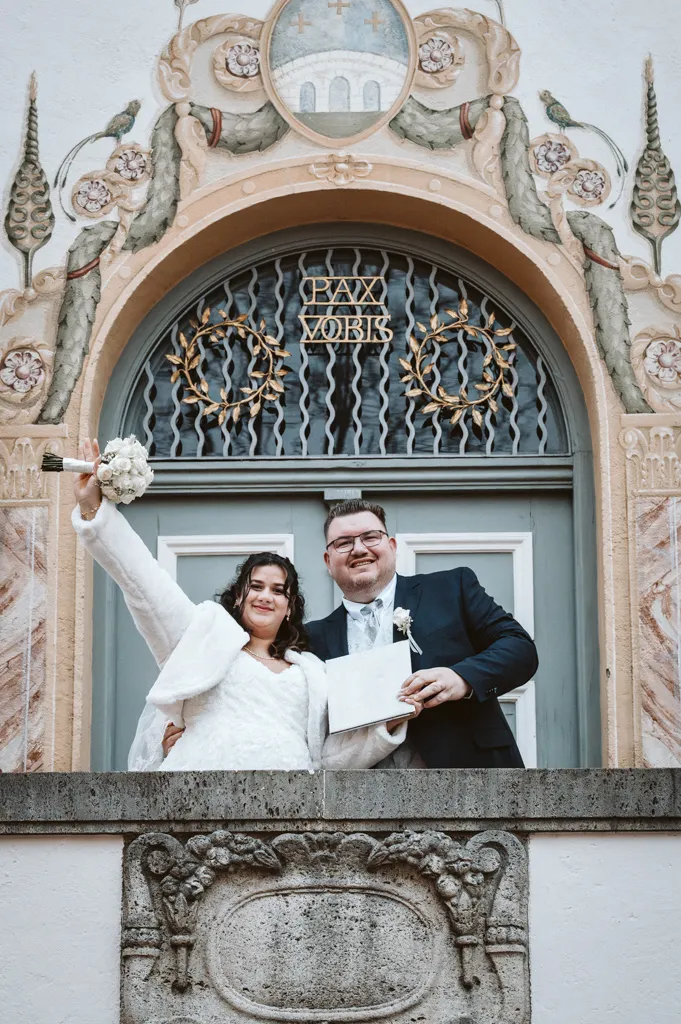 Jubel auf dem Podest vor dem Standesamt Das frisch verheiratete Ehepaar winkt voller Freude vom Balkon des Rathauses Fürstenfeldbruck nach der standesamtlichen Trauung.
